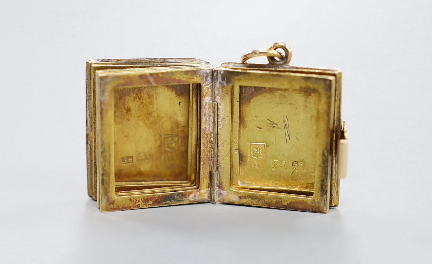 A 19th century Russian 56 zolotnik yellow metal photograph? souvenir case, modelled as a book, opening to reveal five vacant frames, master BF, Tiflus? 1862, 22mm, 10.4 grams.